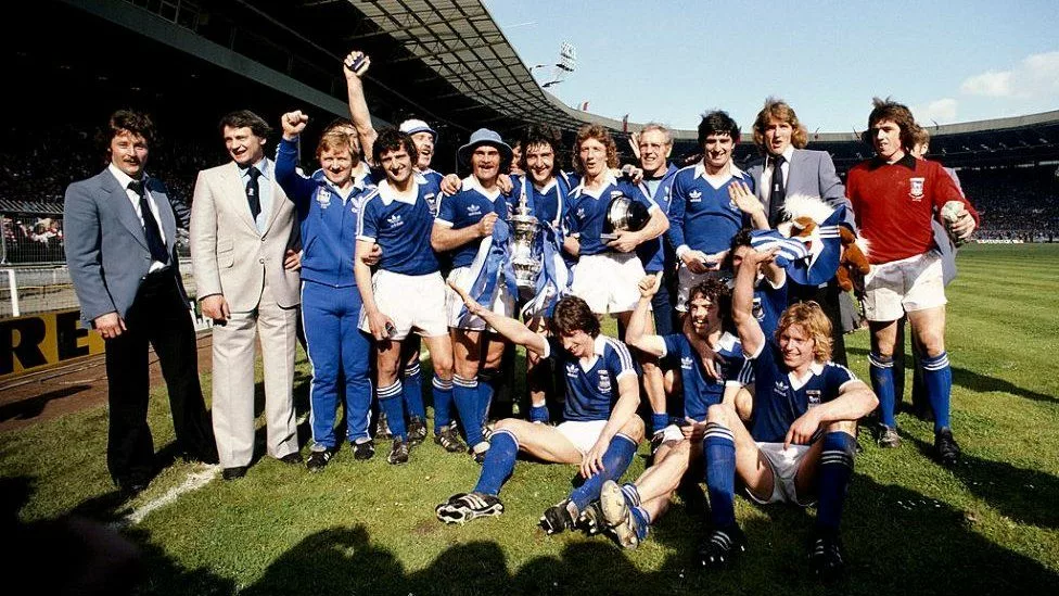 The cup-winning team with Bobby Robson as manager celebrate with the Cup