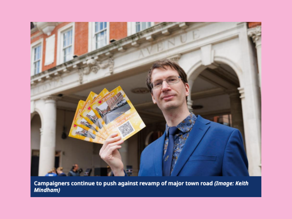 A campaigner standing in front of Lloyds Avenue arches in Ipswich town centre holding up a fan of leaflets