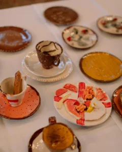 objects made of clay: three cups and saucers and various small dishes with multi-decoration